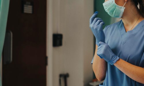 doctor-putting-glove-prevent-coronavirus-contamination